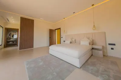 a bedroom with a large white bed in a room at Beautiful new villa with private pool in El Rhechat