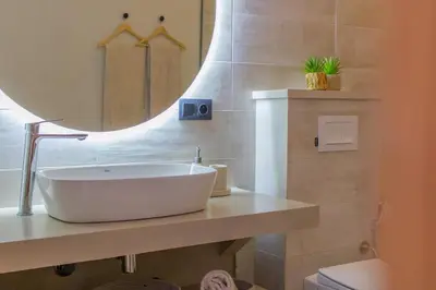 a bathroom with a large white sink and a mirror at Beautiful new villa with private pool in El Rhechat