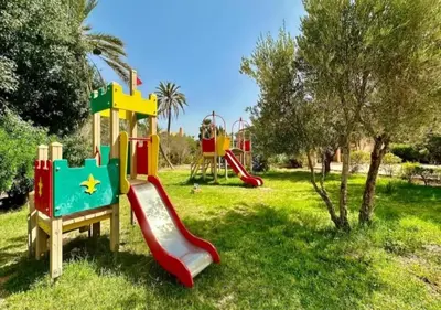 a playground with a slide in a park at L'Oasis Chic Palmeraie Marrakech Piscine & Petit Déj Offert in Marrakech