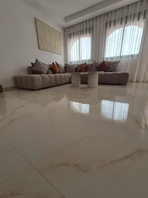 a living room with a couch in the middle of a room at Sumptuous apartment in Premium Village in Marrakech