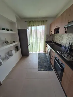 a kitchen with a refrigerator and a counter top at Sumptuous apartment in Premium Village in Marrakech