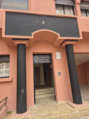 a building with two large columns in front of it at Sumptuous apartment in Premium Village in Marrakech