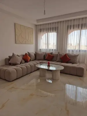 a living room with a couch and a table at Sumptuous apartment in Premium Village in Marrakech