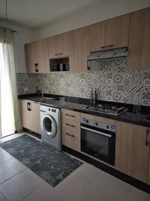 a kitchen with a stove and a washing machine at Sumptuous apartment in Premium Village in Marrakech