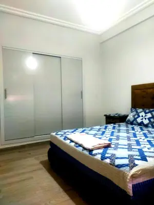 a bedroom with a bed with a sliding glass door at 2-bedroom apartment in Marrakech
