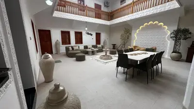 a large living room with a table and chairs at Riad Dari and spa - 8 ROOMS EXCLUSIVITY in Marrakech
