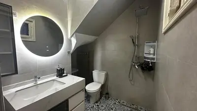 a bathroom with a sink and a toilet and a mirror at Riad Dari and spa - 8 ROOMS EXCLUSIVITY in Marrakech