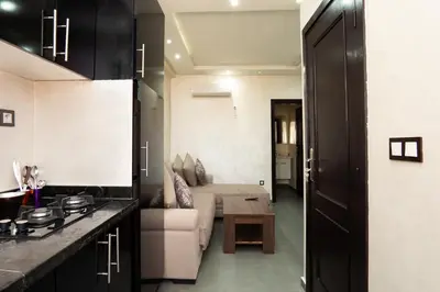 a living room with a couch and a table at Cozy apartment in the hypercenter in Marrakech
