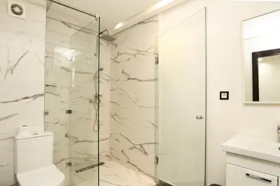 a bathroom with a shower and a toilet and a sink at Cozy apartment in the hypercenter in Marrakech