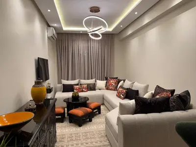 a living room with two couches and a tv at Marrakech Apartment Hivernage in Marrakech