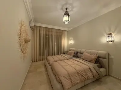 a large bed in a room with a couch at Marrakech Apartment Hivernage in Marrakech