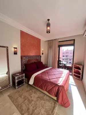 a bedroom with a large bed and a large window at Marrakech Apartment Hivernage in Marrakech