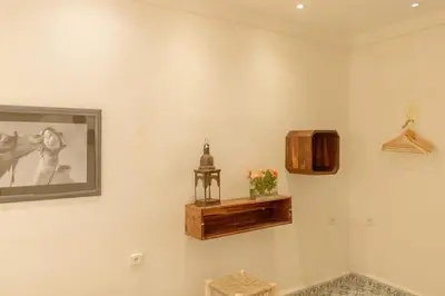 a room with a painting and a picture on the wall at Riad Dar Moulay 120m2 in der Medina mit Terrasse in Marrakech