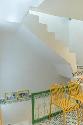 two chairs and a staircase in a house at Riad Dar Moulay 120m2 in der Medina mit Terrasse in Marrakech
