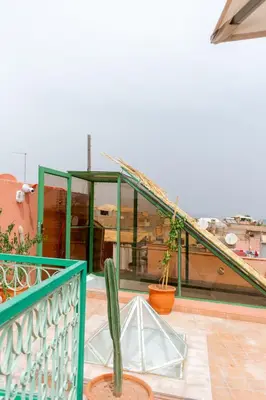 a cactus on the balcony of a house at Riad Dar Moulay 120m2 in der Medina mit Terrasse in Marrakech