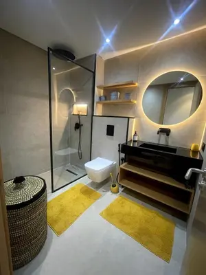 a bathroom with a sink and a toilet and a mirror at Superb apartment with all amenities and pool in Marrakech