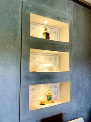 a wall with three shelves with differentiatesiatesiatesiatesiatesiatesiatesiatesiates at Superb apartment with all amenities and pool in Marrakech