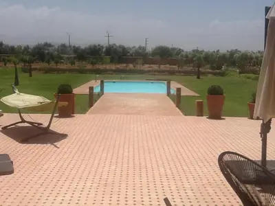 a swimming pool in the middle of a yard at Domaine VILLA in Marrakech