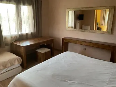 a bedroom with a bed and a mirror and a desk at Domaine VILLA in Marrakech