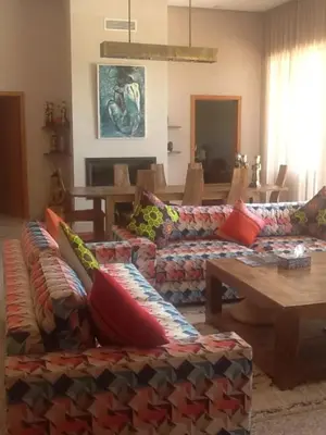a living room with a couch and a table at Domaine VILLA in Marrakech