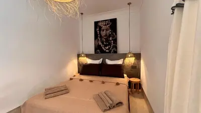 a small bedroom with a bed in a room at Riad Bergamot in Marrakech