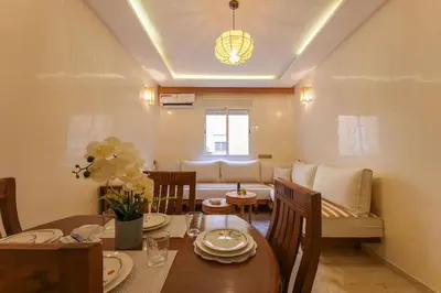 a dining room with a table and a couch at NS 51 by KMREI Properties in Marrakech