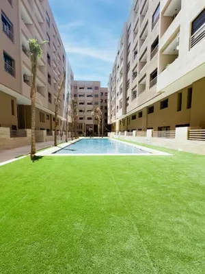an empty courtyard of an apartment building with a swimming pool at Menara Garden Wifi Parking Piscine in Marrakech