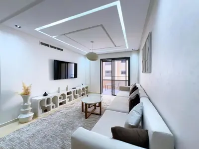 a living room with a couch and a table at Menara Garden Wifi Parking Piscine in Marrakech