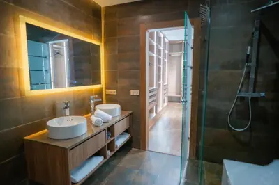 a bathroom with two sinks and a shower at Villa Akenza - Cinema - Swiming pool in Marrakech