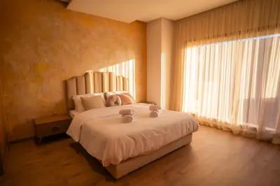 a bedroom with a large bed with a large window at Villa Akenza - Cinema - Swiming pool in Marrakech