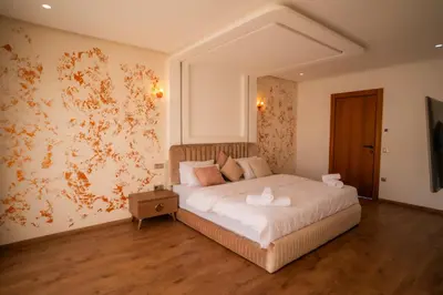 a bedroom with a large white bed in a room at Villa Akenza - Cinema - Swiming pool in Marrakech