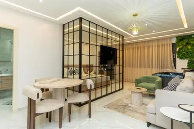 a living room with a tv and a table and chairs at Luxurious apartment ,hot tub in Marrakech