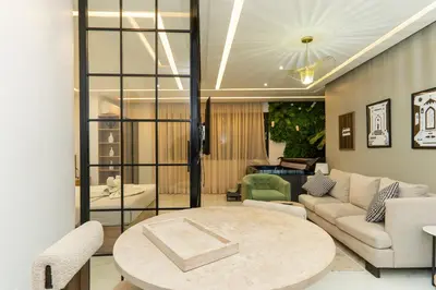 a living room with a couch and a table at Luxurious apartment ,hot tub in Marrakech