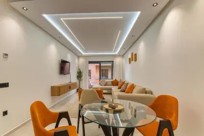 a living room with a couch and a table and chairs at Stylish Hivernage Studio in Marrakech