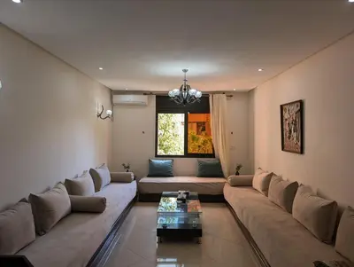 a living room with a couch and a table at Le Cocon Nature in Marrakech