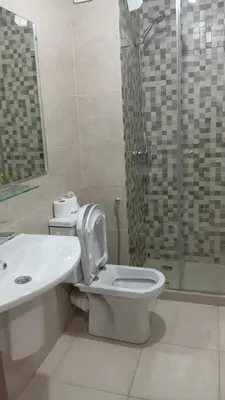 a bathroom with a toilet and a sink and a shower at Two bedroom apartment - Guéliz train station in Marrakech