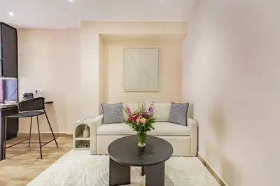 a living room with a couch and a table with a vase of flowers at NOUVEAU à Marrakech in Marrakech