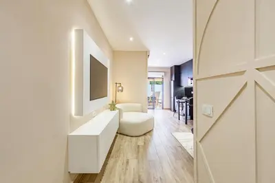 a living room with a white couch and a tv at NOUVEAU à Marrakech in Marrakech