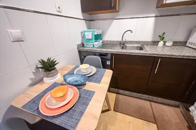 a small kitchen with a table with plates on it at Studio cosy avec piscine et balcon Résidence Mirador Majorelle in Marrakech