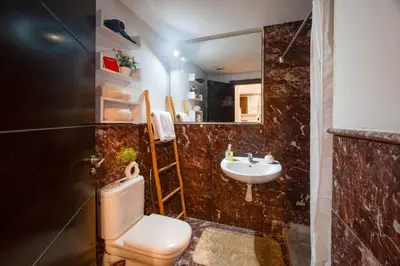 a bathroom with a toilet and a sink at Studio cosy avec piscine et balcon Résidence Mirador Majorelle in Marrakech