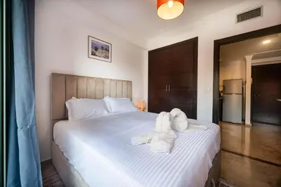 a bedroom with a bed with towels on it at Studio cosy avec piscine et balcon Résidence Mirador Majorelle in Marrakech