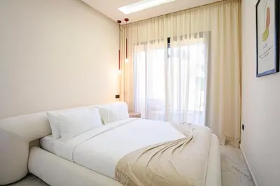 a white bed in a room with a window at Marrakech Éternel - Hivernage in Marrakech