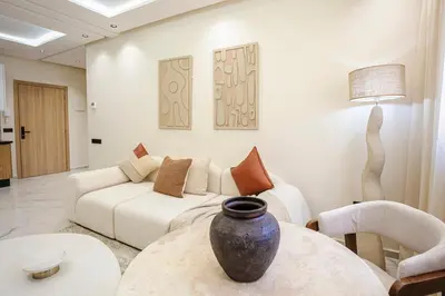 a living room with a couch and a vase on a table at Marrakech Éternel - Hivernage in Marrakech