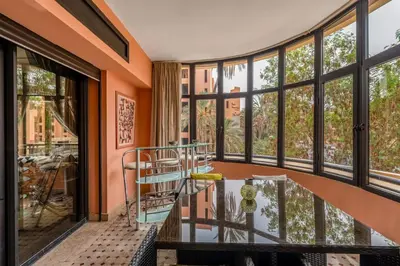 a room with a glass table and large windows at Marrakech GUELIZ Vue Imprenable et Terrasse rare in Marrakech