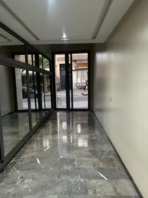 an empty room with glass doors and a stone floor at Regine in Marrakech