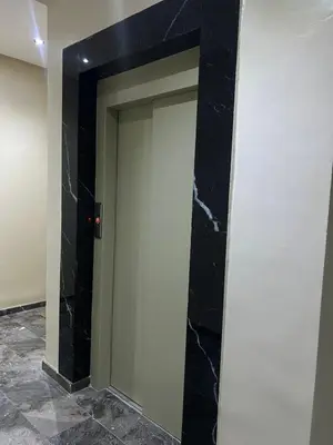 a door in a room with black marble at Regine in Marrakech