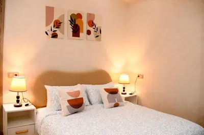 a bedroom with a bed with pillows and two lamps at Regine in Marrakech