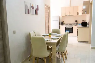 a kitchen and dining room with a table and chairs at Regine in Marrakech