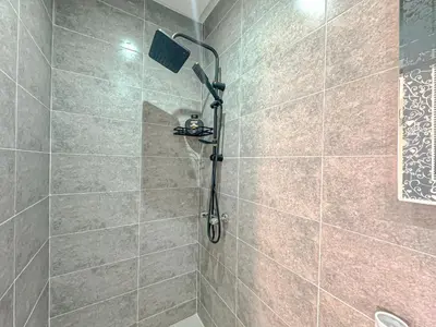 a shower with a shower head in a bathroom at Lumière d'Atlas Calme et Confort in Marrakech