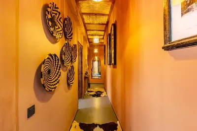 a hallway with a long hallway with a painting on the wall at DAR MA ITTO Charming luxurious Medina Cocoon in Marrakech